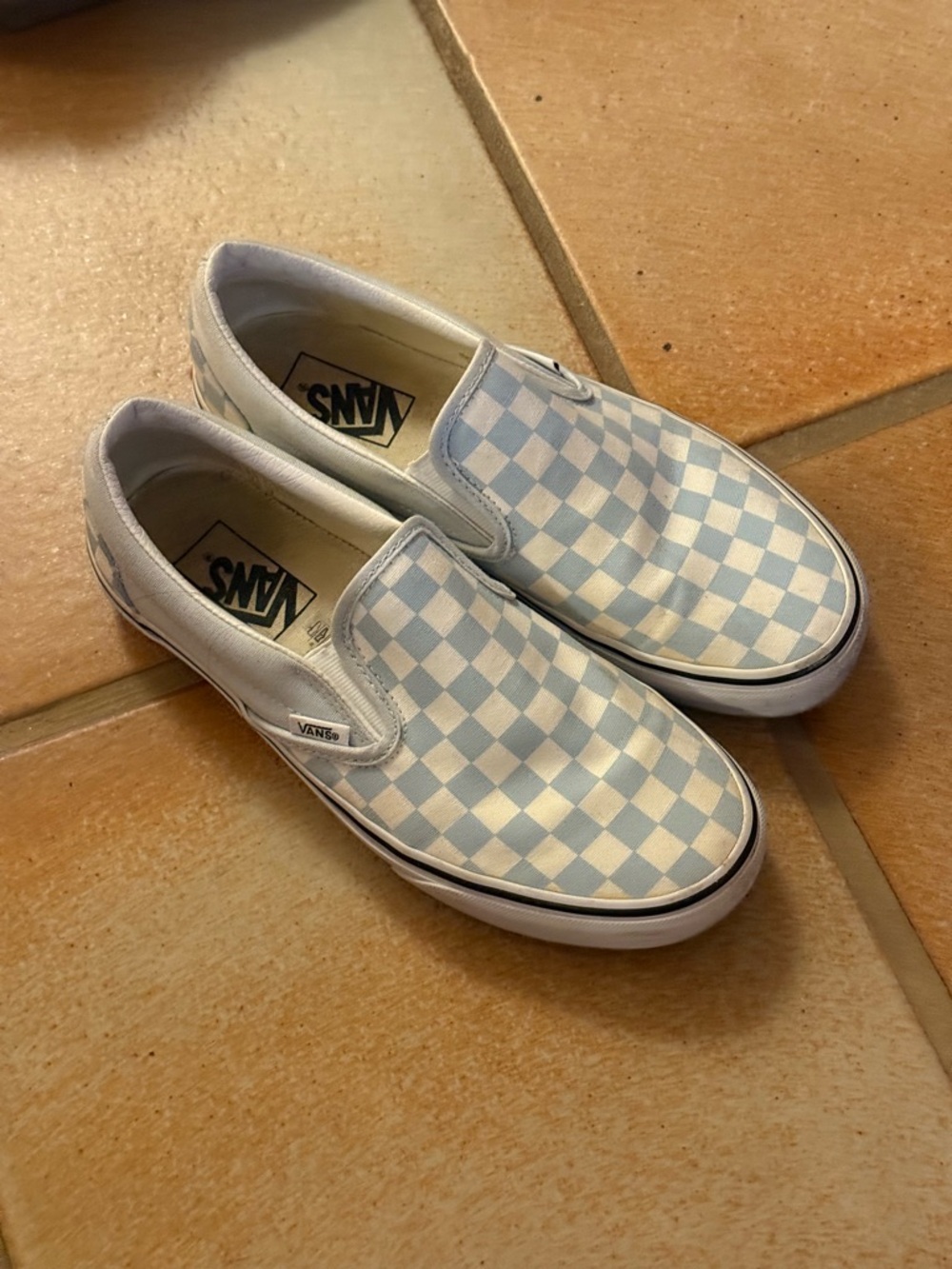 vans slip ons in checkered white and blue